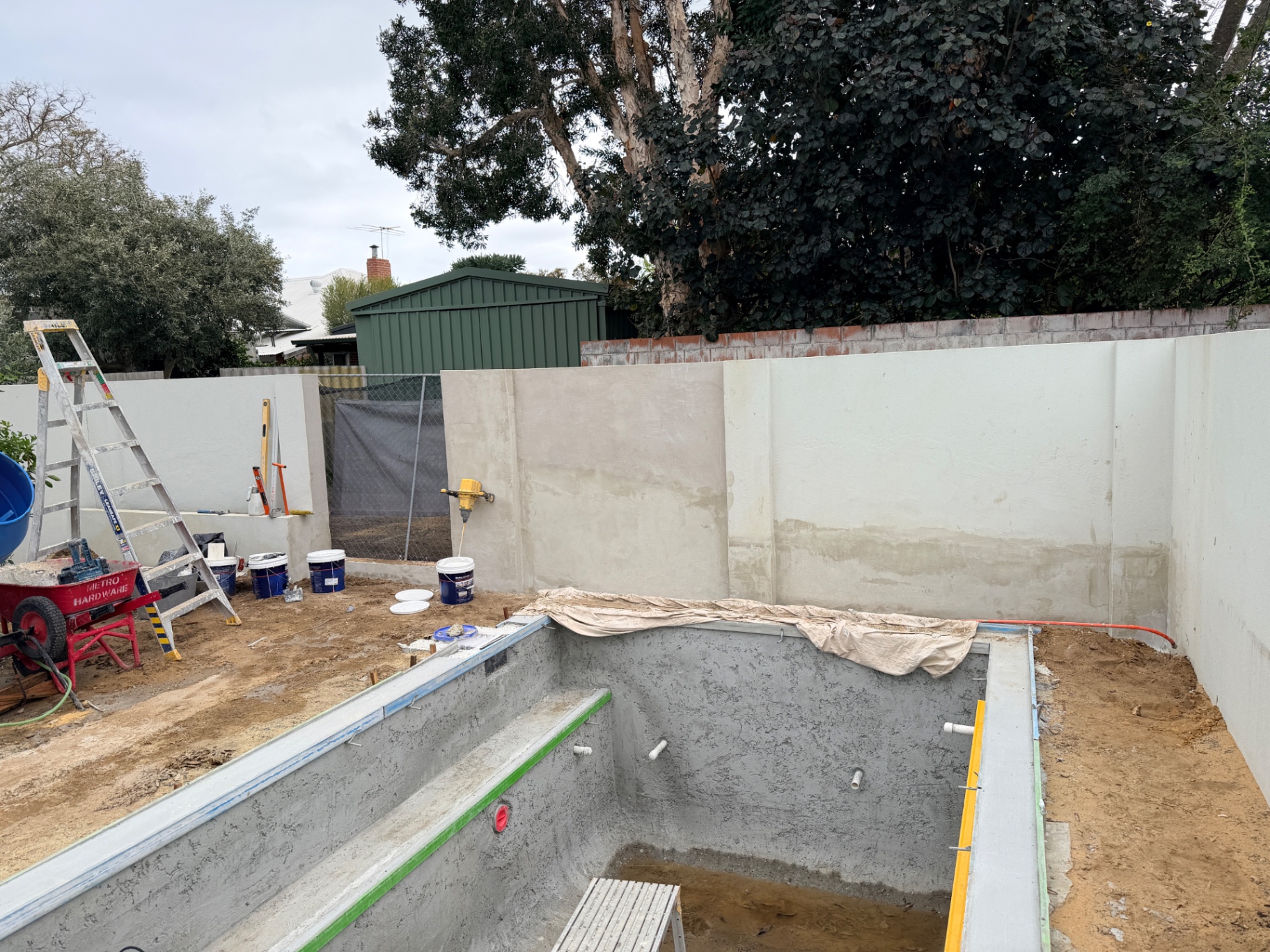 Wide view of the Swanbourne pool wall while re-rendering and surface preparation were in progress