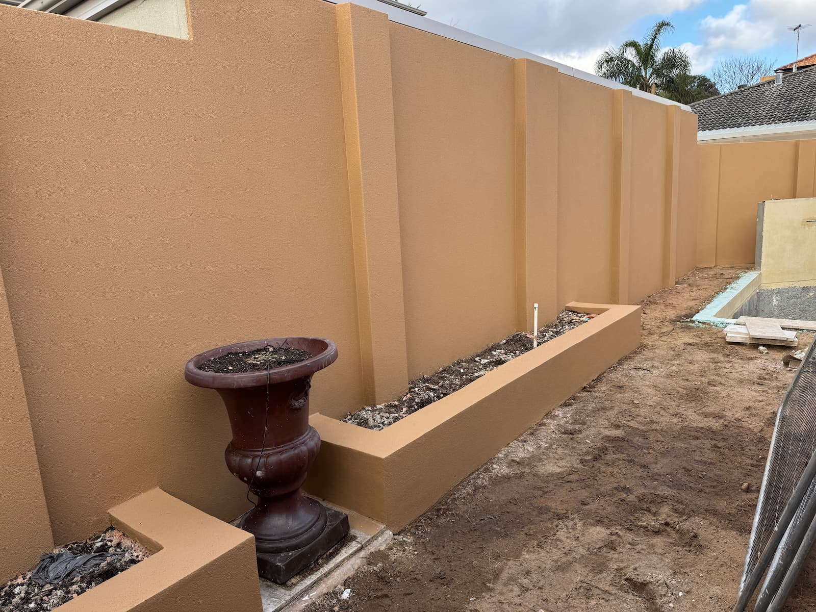 Bicton boundary wall after re-texture and AcraShield finish in a warm sand colour