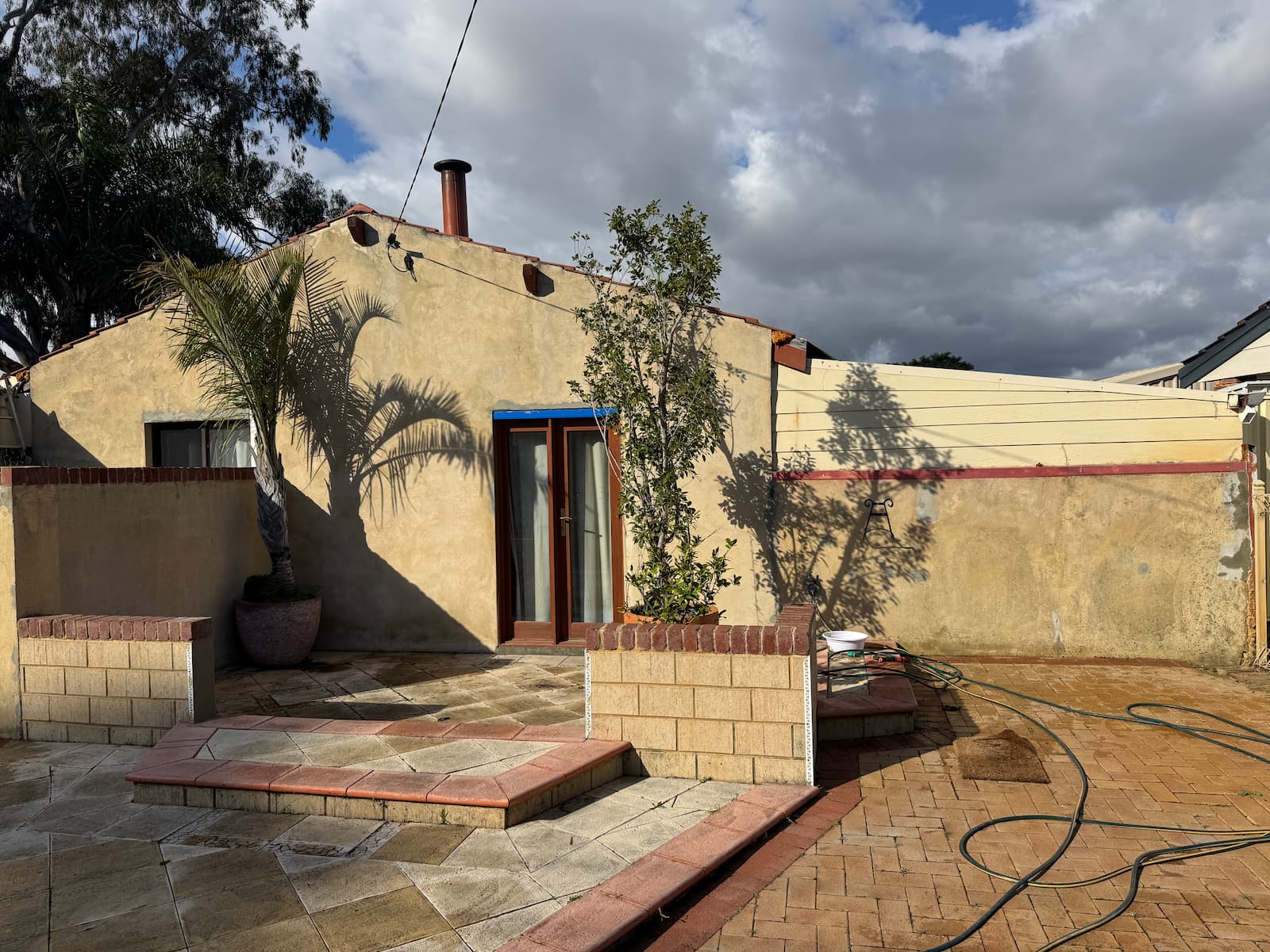 Bibra Lake rear elevation before works, showing stained and patchy render